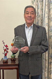 Image of Kai Li holding his glass Judith Buckle award